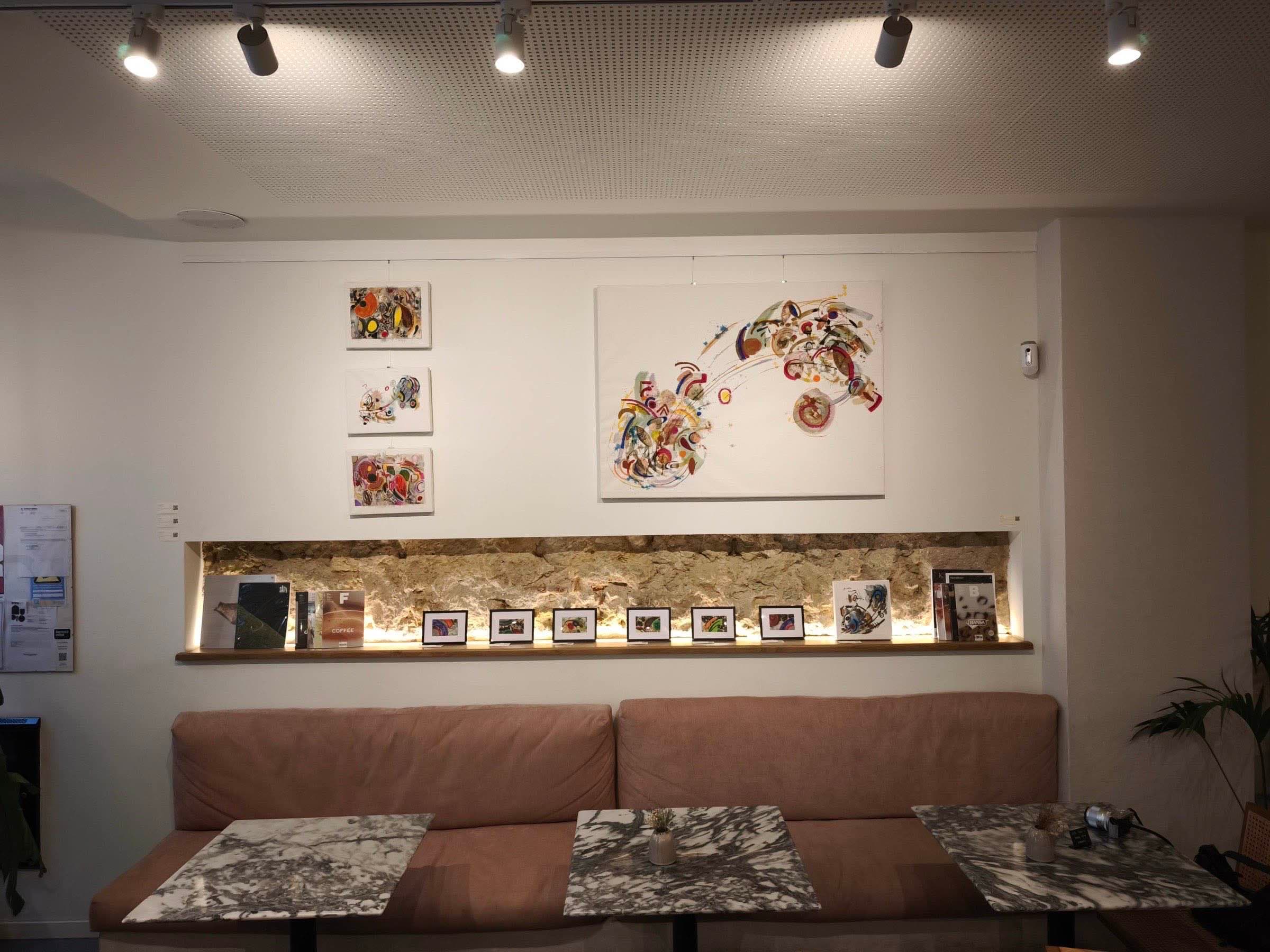 Works by Bianca Castro on the café shelf and wall at Matéria Viva