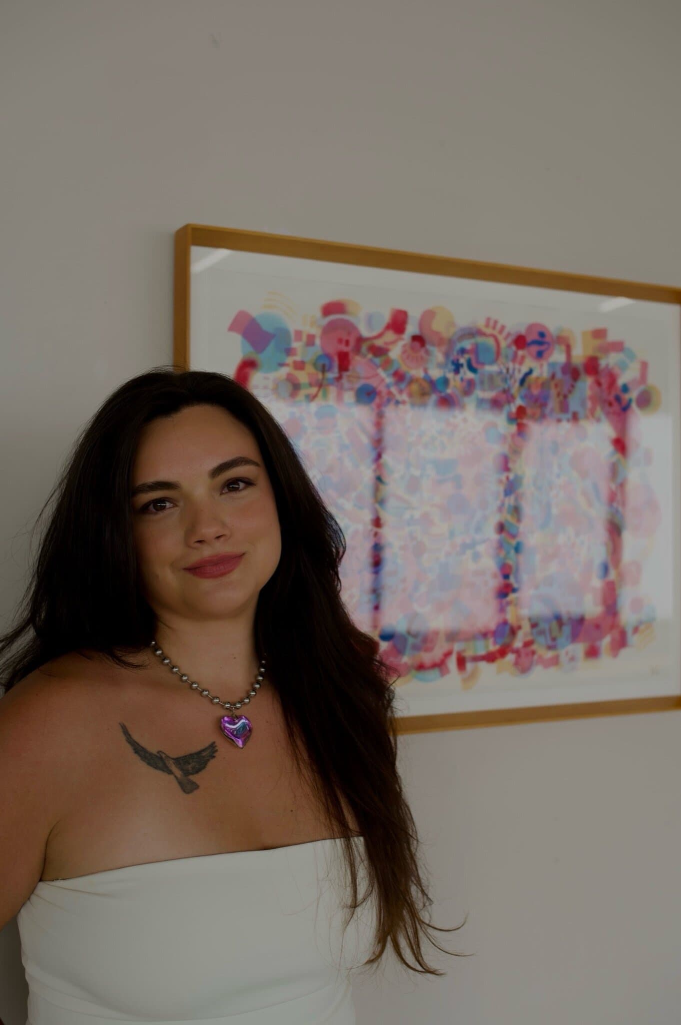 Bianca Castro in front of one of her paintings